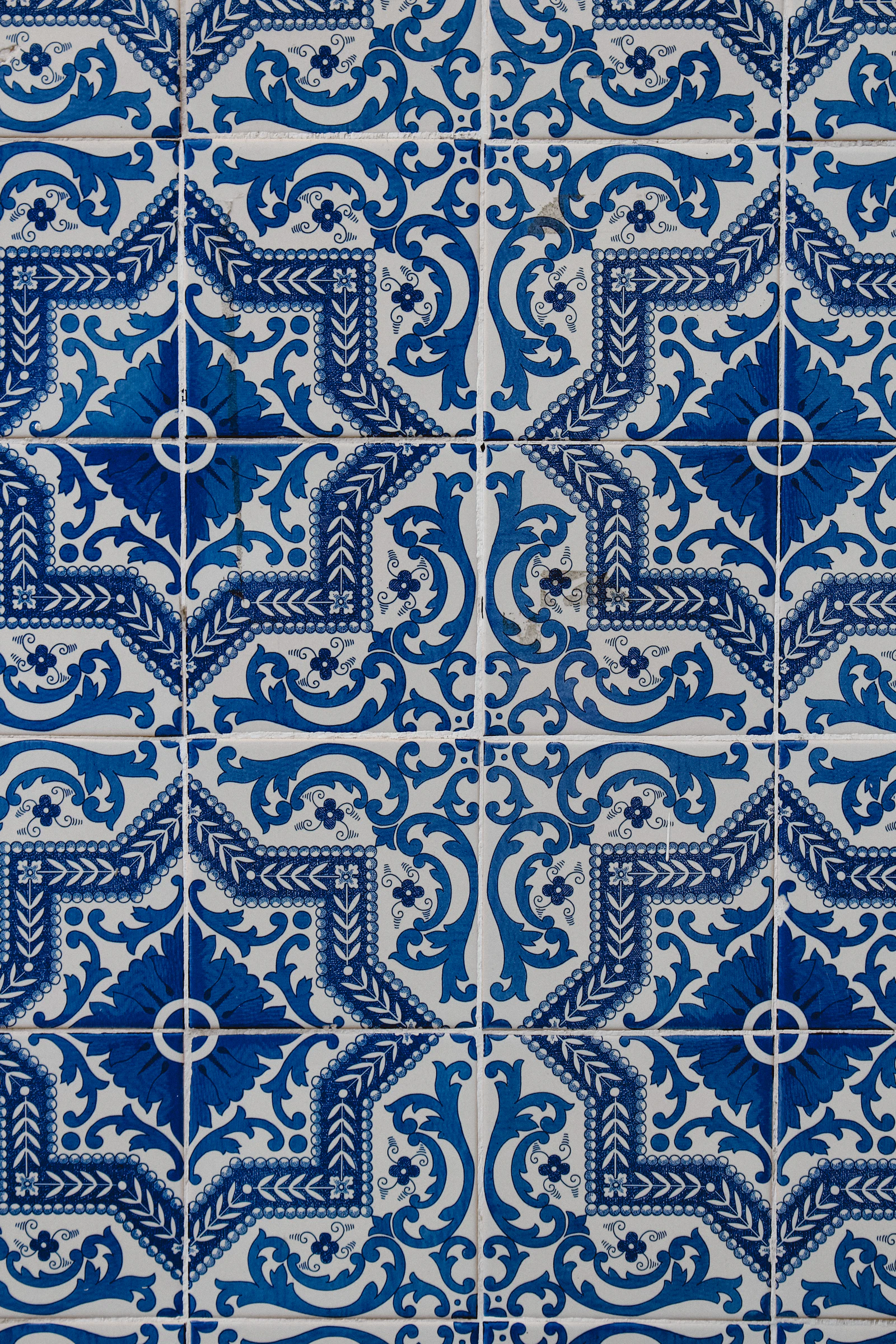 Close-up of weathered blue and white azulejo tiles on a façade