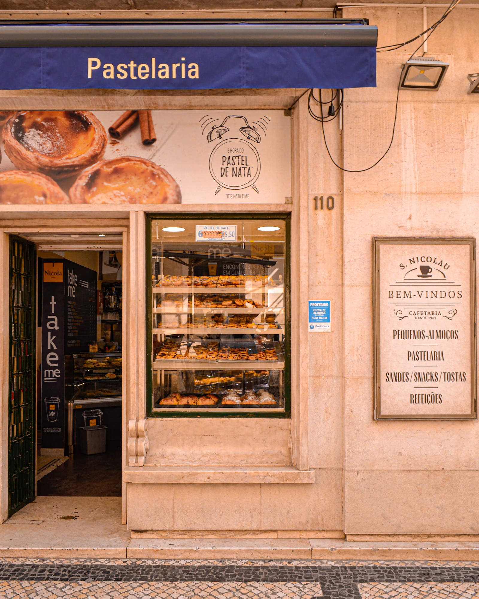Tiny Portuguese café with marble table and bica coffee in a glass cup