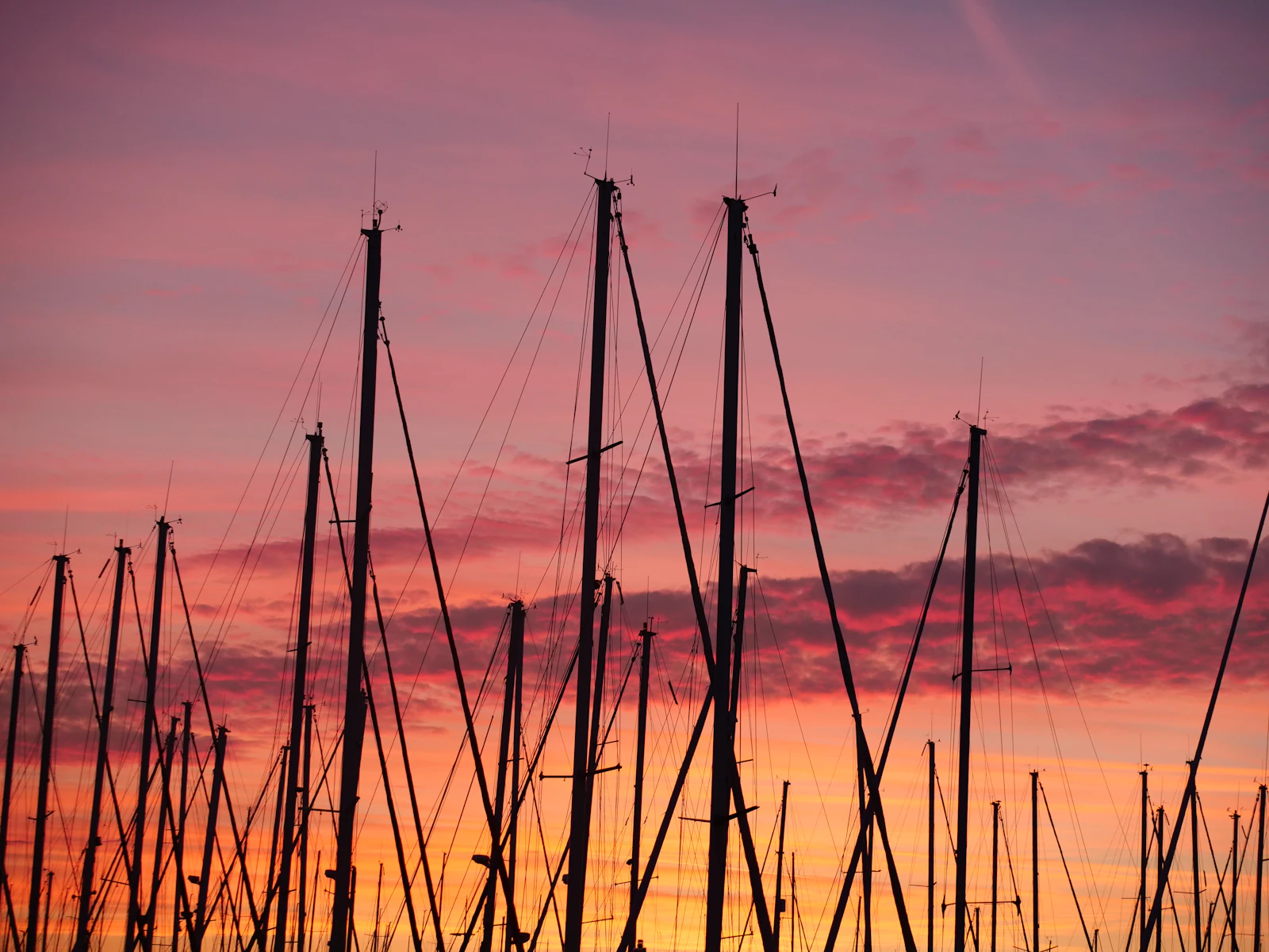 Cascais marina at dusk with masts reflected in still water
