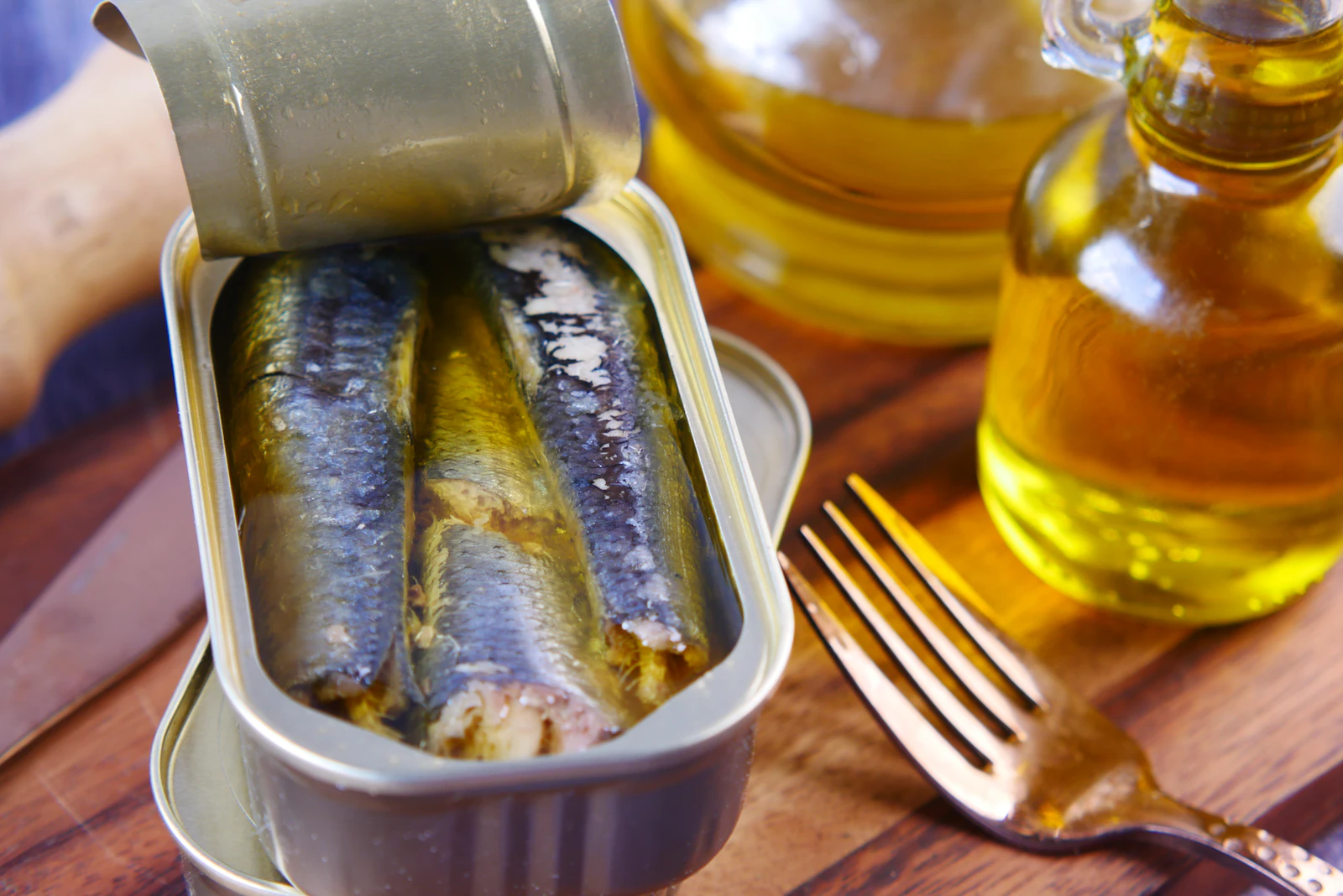 Portuguese ceramic tiles and a sardine tin arranged on linen